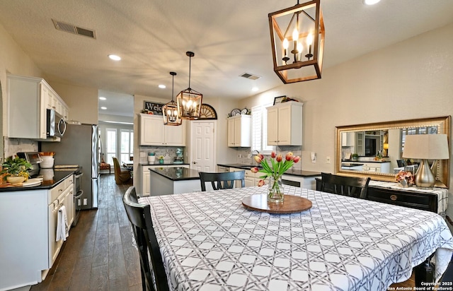 21539 Bubbling Crk, San Antonio, TX 78259 - dining area with a chandelier, dark wood-style flooring, and recessed lighting