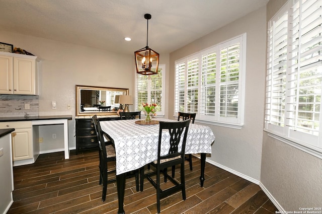 21539 Bubbling Crk, San Antonio, TX 78259 - dining area featuring dark wood-type flooring, a textured wall, a chandelier, and recessed lighting