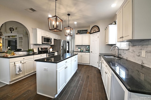 21539 Bubbling Crk, San Antonio, TX 78259 - kitchen featuring appliances with stainless steel finishes, a center island, dark countertops, decorative backsplash, and recessed lighting
