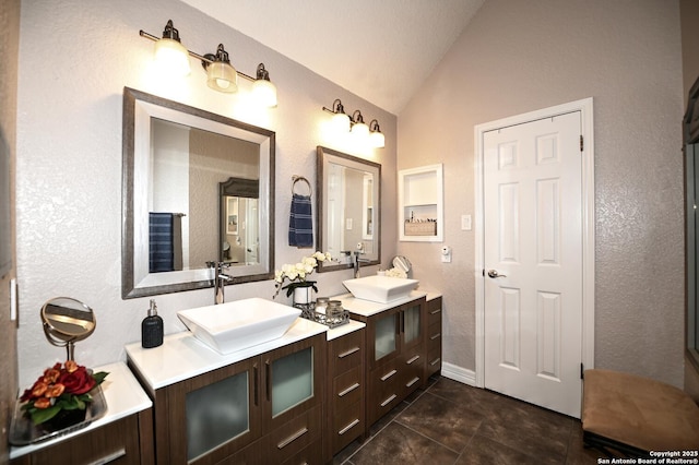 21539 Bubbling Crk, San Antonio, TX 78259 - bathroom with lofted ceiling, double vanity, a textured wall, and tile patterned floors