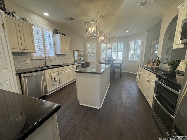 21539 Bubbling Crk, San Antonio, TX 78259 - kitchen featuring appliances with stainless steel finishes, recessed lighting, dark wood-type flooring, a chandelier, and a center island