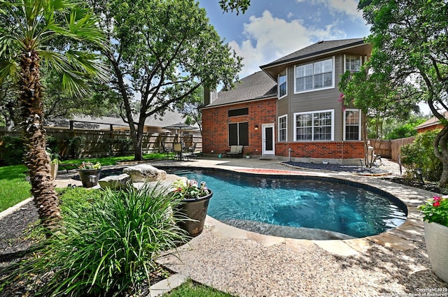 21539 Bubbling Crk, San Antonio, TX 78259 - rear view of house featuring brick siding, a patio, a fenced backyard, a chimney, and a shingled roof