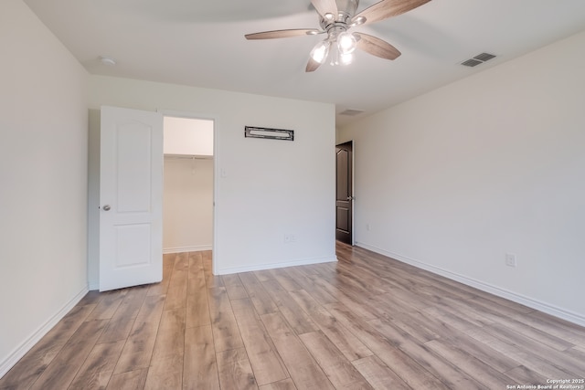 8438 Cordova Pt, San Antonio, TX 78252 - unfurnished bedroom with light wood-style flooring, a spacious closet, a closet, and ceiling fan