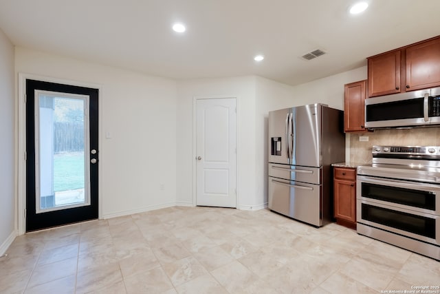 8438 Cordova Pt, San Antonio, TX 78252 - kitchen featuring stainless steel appliances, brown cabinets, recessed lighting, and tasteful backsplash