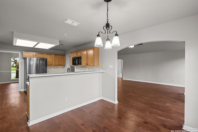 29732 Cojak Cir, Boerne, TX 78015 - kitchen featuring black microwave, arched walkways, light countertops, and dark wood-style floors