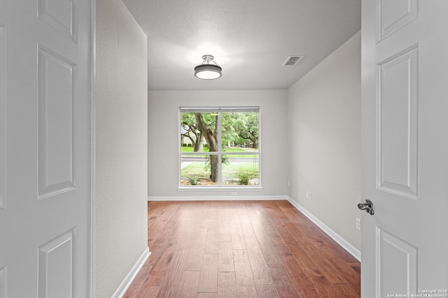29732 Cojak Cir, Boerne, TX 78015 - unfurnished room featuring wood finished floors and a textured ceiling
