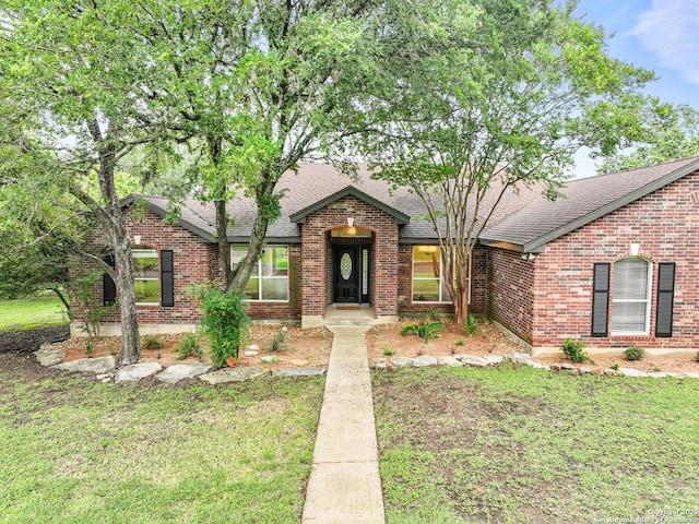 29732 Cojak Cir, Boerne, TX 78015 - view of front of home featuring roof with shingles, brick siding, and a front yard