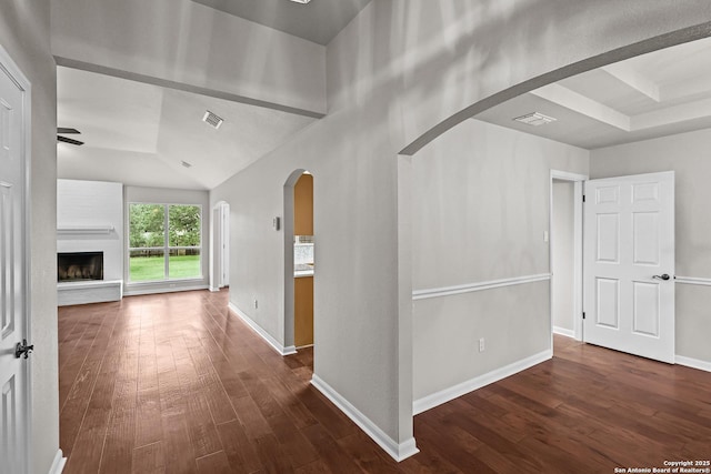 29732 Cojak Cir, Boerne, TX 78015 - hallway featuring dark wood finished floors, arched walkways, and lofted ceiling