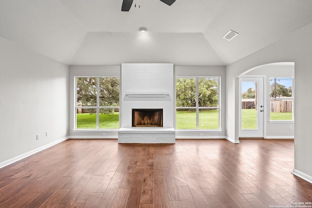 29732 Cojak Cir, Boerne, TX 78015 - unfurnished living room with vaulted ceiling, a ceiling fan, a large fireplace, plenty of natural light, and arched walkways