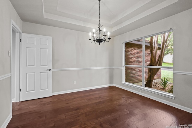 29732 Cojak Cir, Boerne, TX 78015 - unfurnished dining area with a chandelier, a raised ceiling, and dark wood-style floors