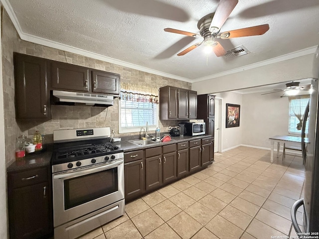 2434 Delgado, San Antonio, TX 78228 - kitchen with appliances with stainless steel finishes, under cabinet range hood, ceiling fan, ornamental molding, and dark countertops