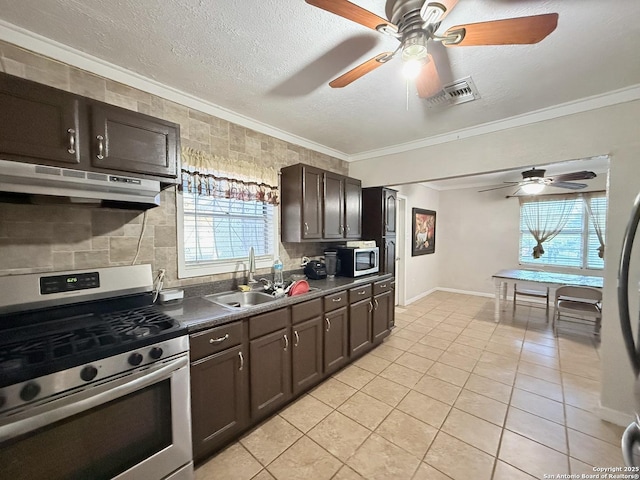 2434 Delgado, San Antonio, TX 78228 - kitchen featuring stainless steel appliances, under cabinet range hood, dark countertops, ornamental molding, and dark brown cabinetry