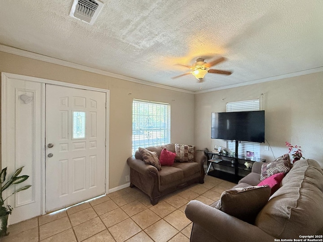 2434 Delgado, San Antonio, TX 78228 - living room featuring light tile patterned floors, ornamental molding, ceiling fan, and a textured ceiling