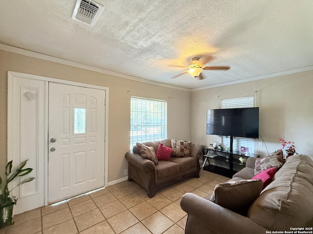 2434 Delgado, San Antonio, TX 78228 - living room featuring light tile patterned floors, a textured ceiling, a ceiling fan, and crown molding