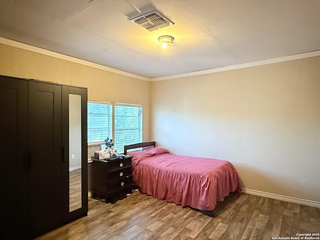 2434 Delgado, San Antonio, TX 78228 - bedroom featuring light wood finished floors and crown molding