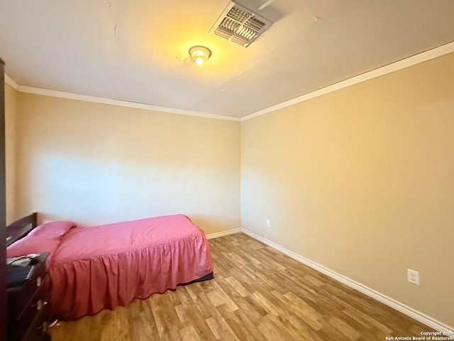 2434 Delgado, San Antonio, TX 78228 - bedroom with ornamental molding and light wood finished floors