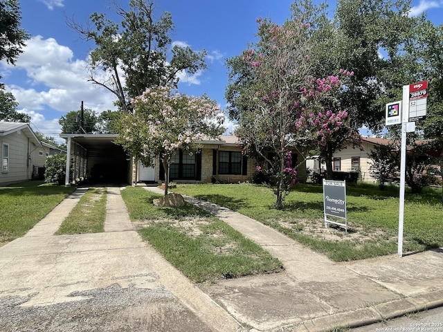 203 Galway, San Antonio, TX 78223 - view of front facade with concrete driveway, a front yard, and a carport