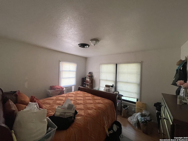 203 Galway, San Antonio, TX 78223 - bedroom with a textured ceiling and wood finished floors