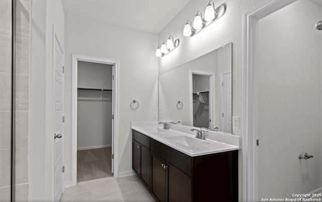2520 Seabream Dr, San Antonio, TX 78253 - bathroom featuring a walk in closet, double vanity, and tile patterned flooring