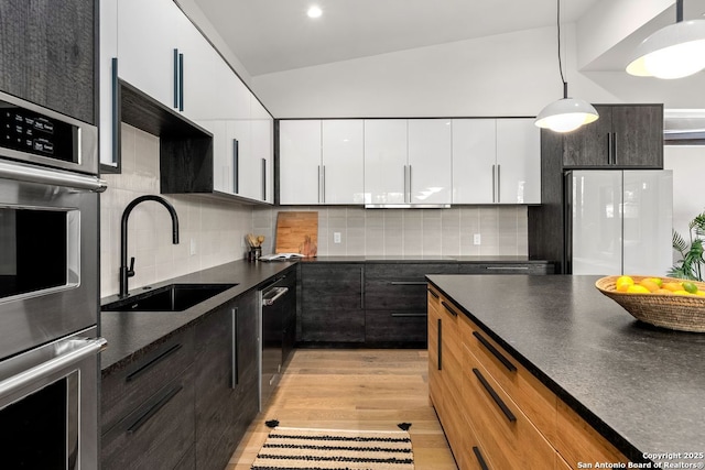 238 Cassiano St, San Antonio, TX 78204 - kitchen with appliances with stainless steel finishes, dark countertops, white cabinetry, and modern cabinets