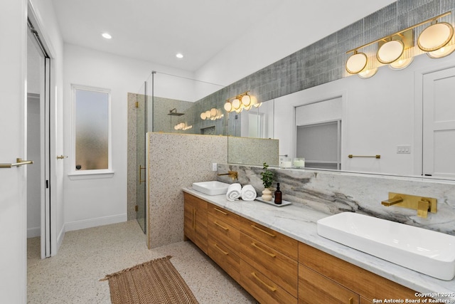 238 Cassiano St, San Antonio, TX 78204 - bathroom with a stall shower, double vanity, recessed lighting, and speckle patterned floor