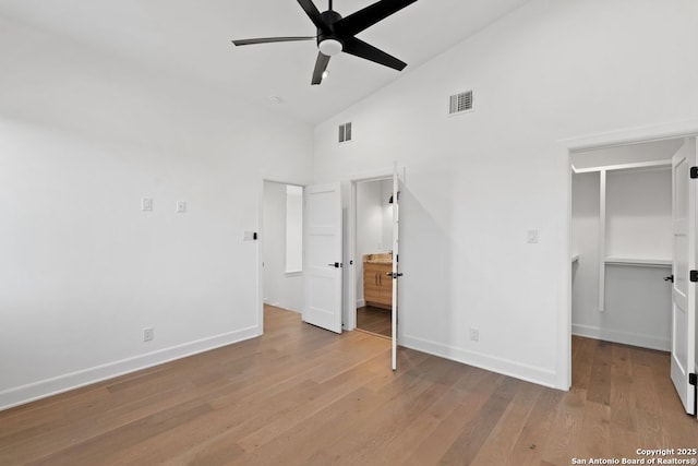 238 Cassiano St, San Antonio, TX 78204 - unfurnished bedroom with high vaulted ceiling, a walk in closet, wood finished floors, ensuite bathroom, and a closet
