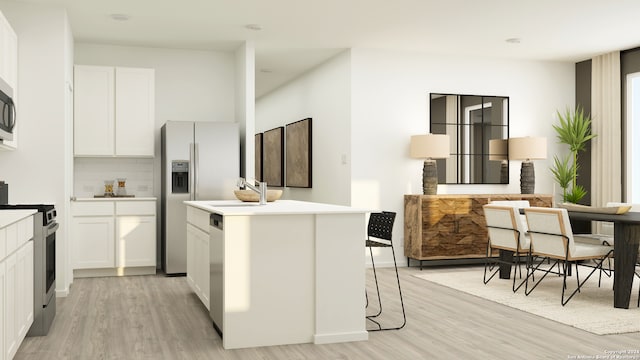 7012 Biotite Rdg, San Antonio, TX 78223 - kitchen featuring stainless steel appliances, light wood-style floors, a center island with sink, light countertops, and white cabinetry