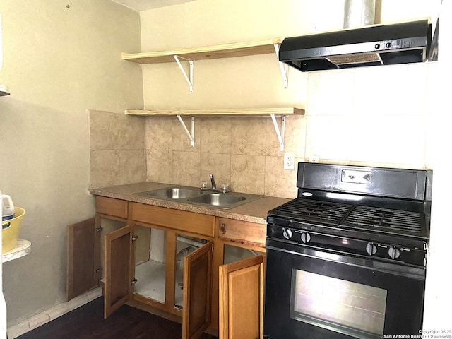 1538 Brighton, San Antonio, TX 78211 - kitchen with black range with gas stovetop, exhaust hood, open shelves, brown cabinets, and dark wood-style flooring
