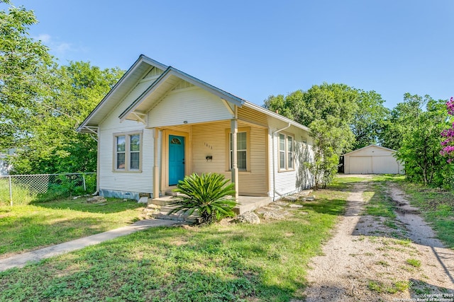 1013 Sacramento, San Antonio, TX 78201 - bungalow-style house with dirt driveway, covered porch, an outdoor structure, and a detached garage