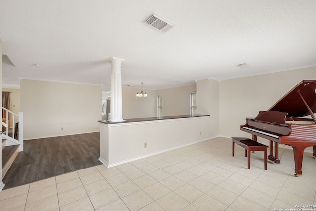 18706 Redriver, San Antonio, TX 78259 - sitting room featuring decorative columns, ornamental molding, stairs, a chandelier, and tile patterned flooring