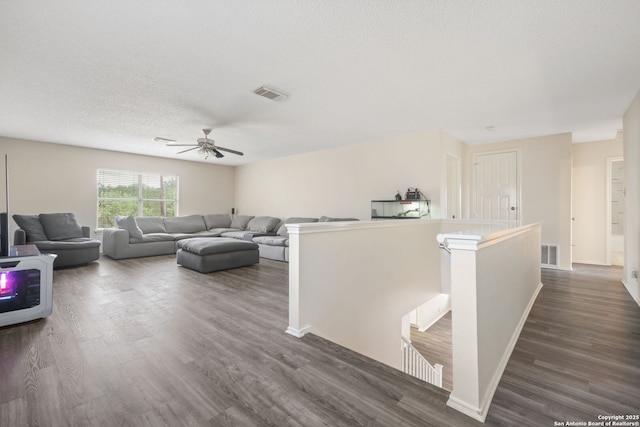 18706 Redriver, San Antonio, TX 78259 - living room with dark wood-style flooring, ceiling fan, and a textured ceiling