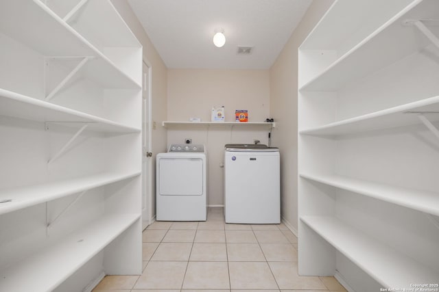 18706 Redriver, San Antonio, TX 78259 - laundry area with independent washer and dryer, light tile patterned flooring, and water heater
