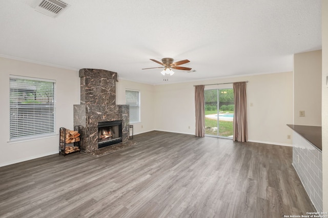 18706 Redriver, San Antonio, TX 78259 - unfurnished living room with wood finished floors, a large fireplace, ceiling fan, and crown molding