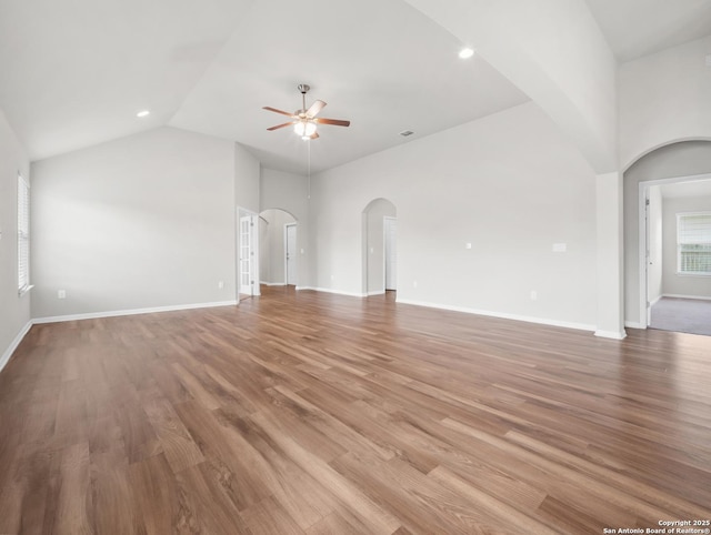 10333 Laurie Ln, Austin, TX 78747 - unfurnished living room featuring ceiling fan, arched walkways, light wood-type flooring, high vaulted ceiling, and recessed lighting