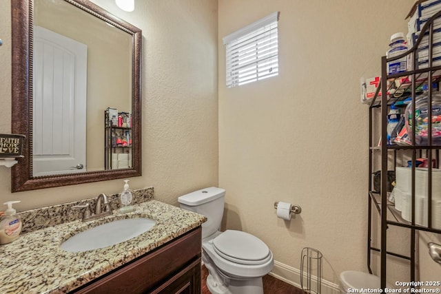4603 Camden, San Antonio, TX 78261 - half bathroom with vanity, a textured wall, and wood finished floors
