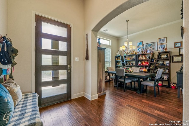 4603 Camden, San Antonio, TX 78261 - foyer entrance featuring arched walkways, a chandelier, wood-type flooring, and crown molding
