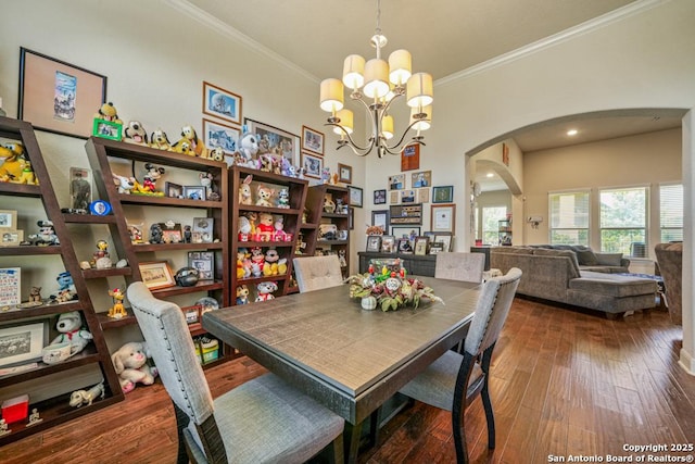4603 Camden, San Antonio, TX 78261 - dining area with arched walkways, a chandelier, crown molding, and hardwood / wood-style flooring