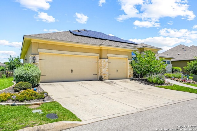 4603 Camden, San Antonio, TX 78261 - prairie-style home with a garage, stone siding, solar panels, stucco siding, and concrete driveway
