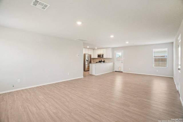 6407 Ignacio, San Antonio, TX 78220 - unfurnished living room featuring light wood finished floors and recessed lighting