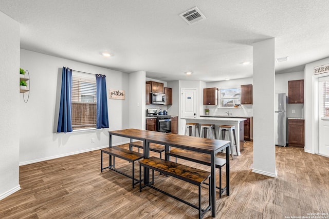 1006 Pacific Monarch, San Antonio, TX 78253 - dining room with wood finished floors, recessed lighting, and a textured ceiling