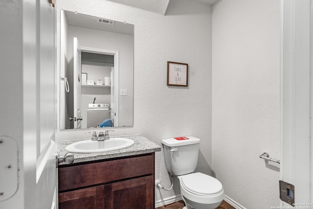 1006 Pacific Monarch, San Antonio, TX 78253 - bathroom with washer / clothes dryer, vanity, and a textured wall