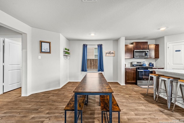 1006 Pacific Monarch, San Antonio, TX 78253 - kitchen featuring stainless steel appliances, wood finished floors, a textured ceiling, dark brown cabinets, and recessed lighting