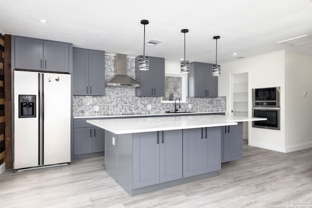 2165 Colleen Dr, Canyon Lake, TX 78133 - kitchen with wall chimney range hood, stainless steel appliances, gray cabinets, decorative backsplash, and recessed lighting