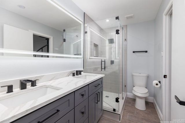 2165 Colleen Dr, Canyon Lake, TX 78133 - full bathroom featuring double vanity, a stall shower, wood finish floors, and recessed lighting