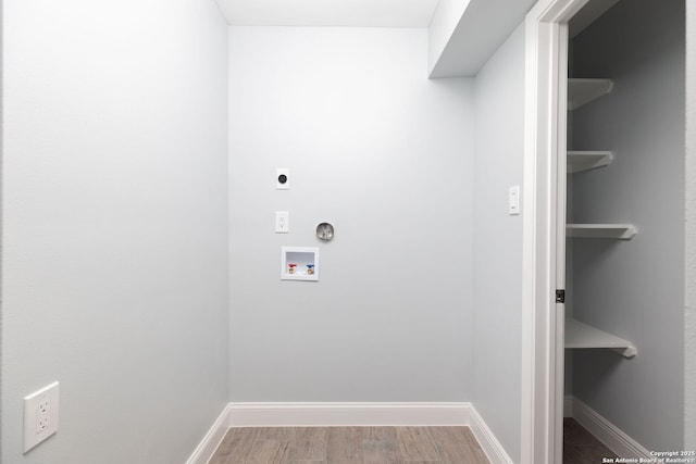 2165 Colleen Dr, Canyon Lake, TX 78133 - washroom featuring washer hookup, hookup for an electric dryer, and wood finished floors