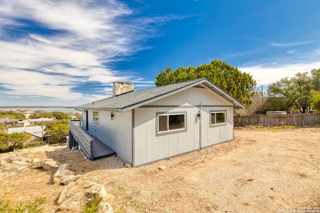2165 Colleen Dr, Canyon Lake, TX 78133 - view of side of property with a chimney and a shingled roof