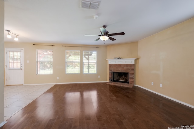 11922 Briarton Wls, San Antonio, TX 78254 - unfurnished living room with wood finished floors, a fireplace, and ceiling fan