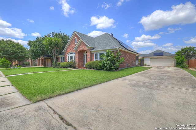 2363 Oak Pebble, New Braunfels, TX 78132 - traditional home with brick siding, roof with shingles, driveway, an outdoor structure, and a garage
