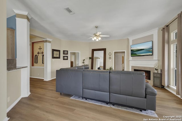 2363 Oak Pebble, New Braunfels, TX 78132 - living room with a ceiling fan, a fireplace, wood finished floors, and decorative columns