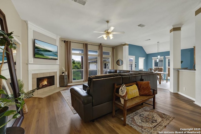 2363 Oak Pebble, New Braunfels, TX 78132 - living area with a ceiling fan, plenty of natural light, a tile fireplace, dark wood-style flooring, and vaulted ceiling